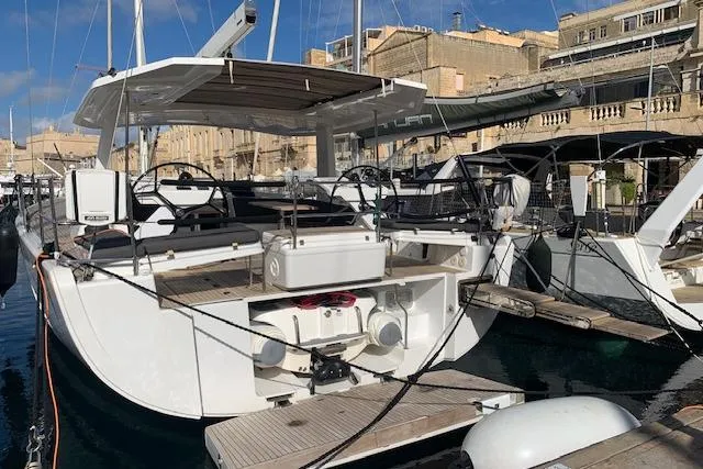  Yacht Photos Pics 2017 Hanse 588 yacht docked in a marina, showcasing sleek design and modern features.