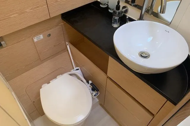  Yacht Photos Pics Modern bathroom in 2017 Hanse 588 yacht with sleek sink and compact toilet.