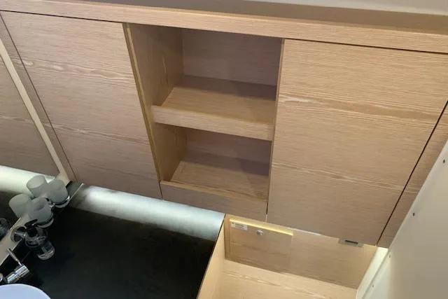  Yacht Photos Pics Wooden cabinetry with open shelves and drawer in a 2017 Hanse 588 yacht interior.