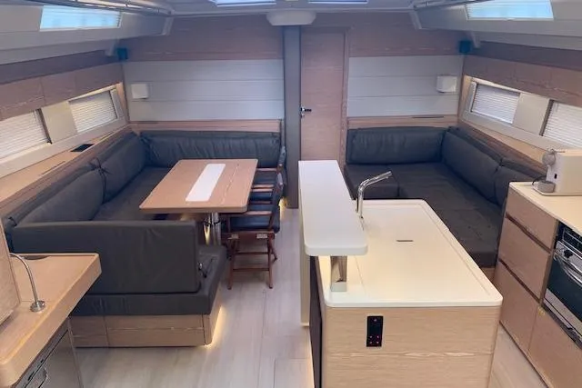  Yacht Photos Pics Luxurious interior of 2017 Hanse 588 yacht with modern kitchen and seating area.