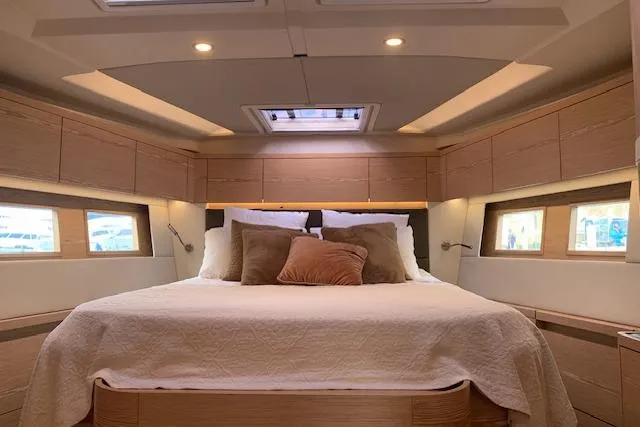  Yacht Photos Pics Luxurious interior of 2017 Hanse 588 yacht with cozy bed and elegant wood finish.
