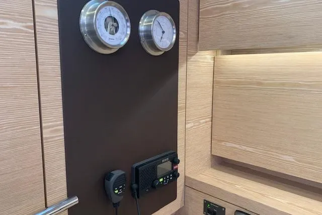  Yacht Photos Pics Interior of 2017 Hanse 588 yacht with navigation instruments and wooden paneling.