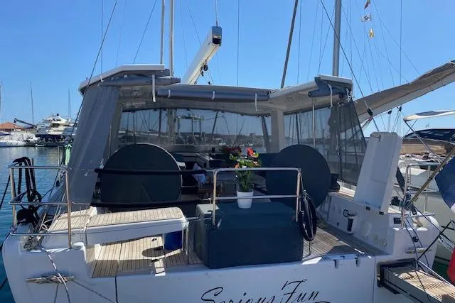  Yacht Photos Pics 2017 Hanse 588 yacht docked, featuring spacious deck and seating area under clear blue sky.