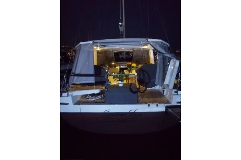  Yacht Photos Pics 2017 Hanse 588 yacht illuminated at night, showcasing elegant interior and deck.