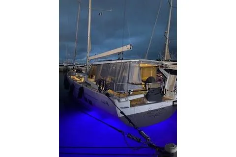  Yacht Photos Pics Hanse 588 yacht, 2017 model, docked at night with blue underwater lights.
