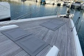  Yacht Photos Pics 2017 Hanse 588 yacht deck with sun pads, docked in a marina.