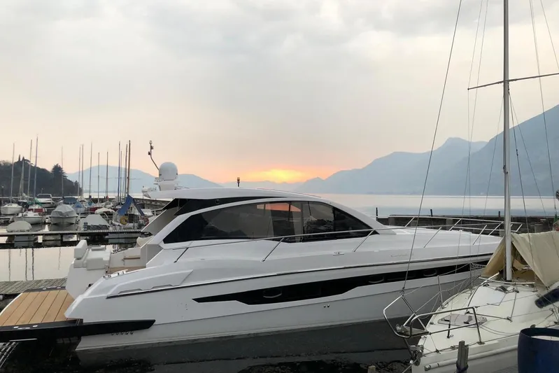  Yacht Photos Pics 2017 Rio Yachts Sport Coupe 44 docked at sunset with scenic mountain backdrop.