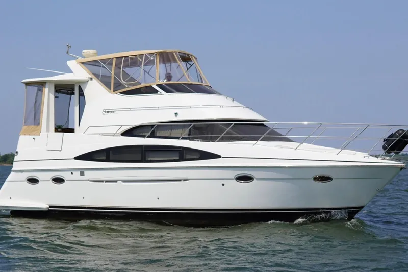  Yacht Photos Pics 2003 Carver 396 Motor Yacht cruising on open water, showcasing sleek design and luxury features.