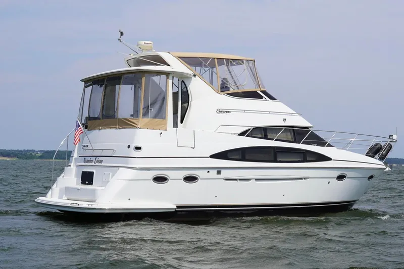  Yacht Photos Pics 2003 Carver 396 Motor Yacht cruising on open water, featuring elegant design and spacious deck.