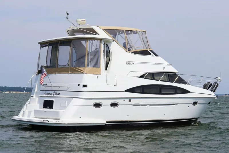 Yacht Photos Pics 2003 Carver 396 Motor Yacht cruising on open water, featuring elegant design and spacious deck.