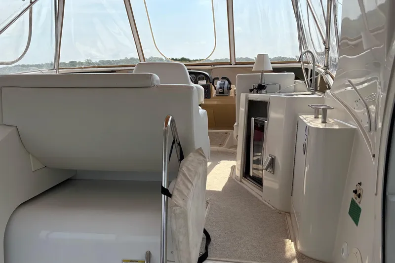  Yacht Photos Pics Interior view of 2003 Carver 396 Motor Yacht, featuring helm and seating area.