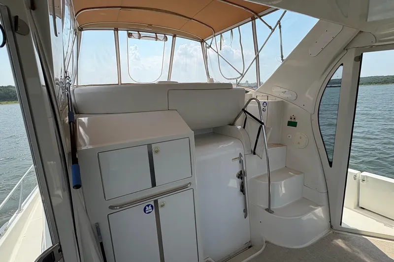  Yacht Photos Pics 2003 Carver 396 Motor Yacht interior with stairs, cabinets, and water view.