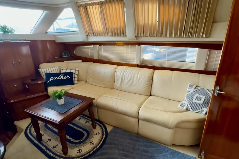  Yacht Photos Pics Luxurious interior of 2003 Carver 396 Motor Yacht with cream leather sofa and nautical decor.