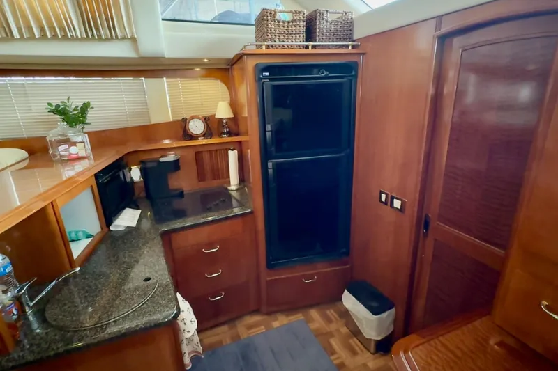  Yacht Photos Pics Interior of 2003 Carver 396 Motor Yacht with kitchen amenities and wooden cabinetry.