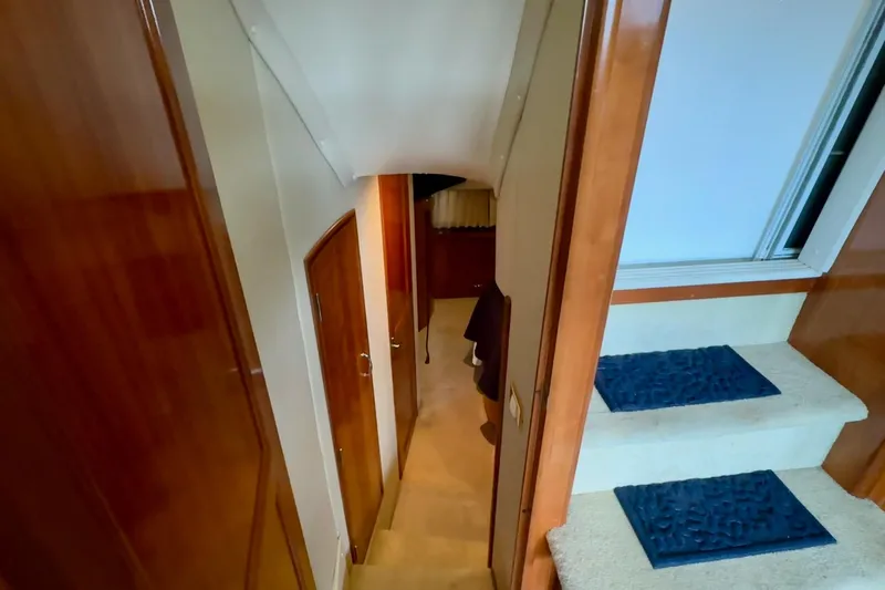  Yacht Photos Pics Interior view of 2003 Carver 396 Motor Yacht, featuring wooden doors and carpeted stairs.