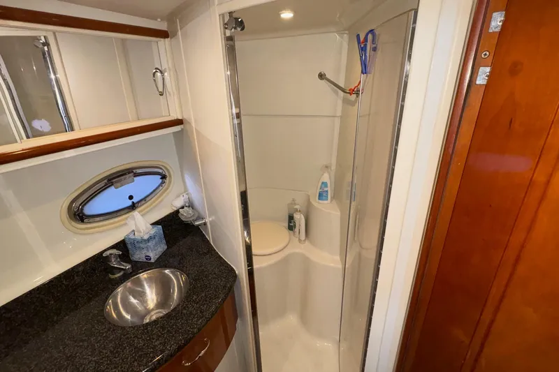  Yacht Photos Pics 2003 Carver 396 Motor Yacht bathroom with shower, sink, and porthole window.