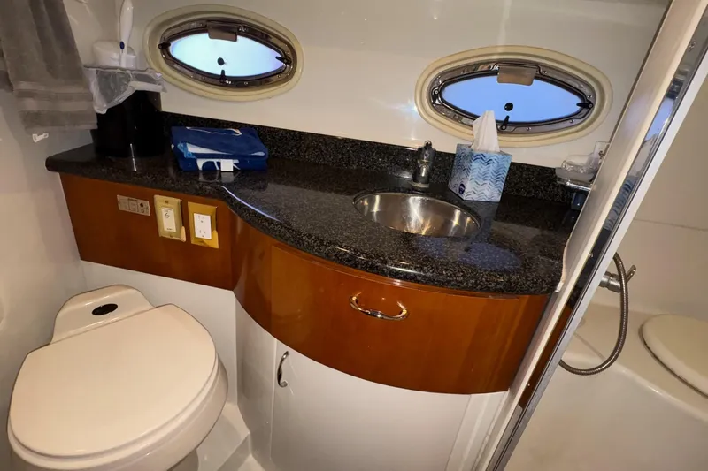  Yacht Photos Pics Luxurious bathroom in 2003 Carver 396 Motor Yacht with granite countertop and porthole windows.