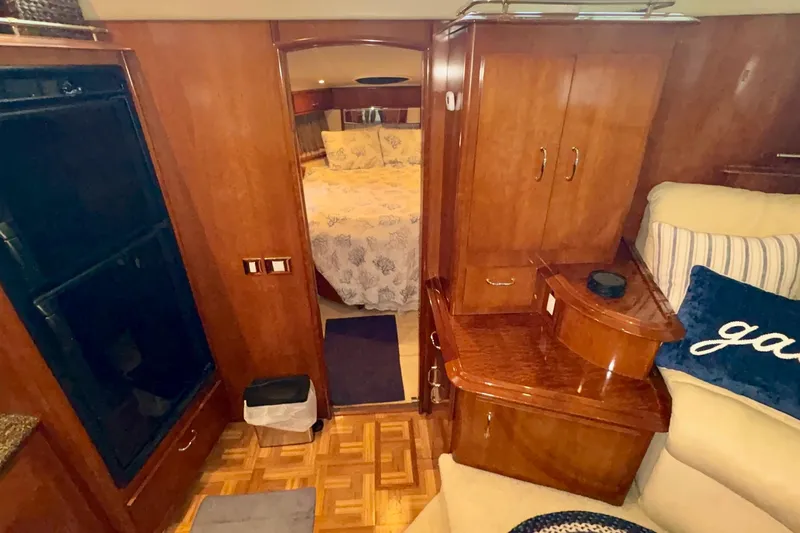  Yacht Photos Pics 2003 Carver 396 Motor Yacht interior with wood cabinetry and cozy bedroom view.