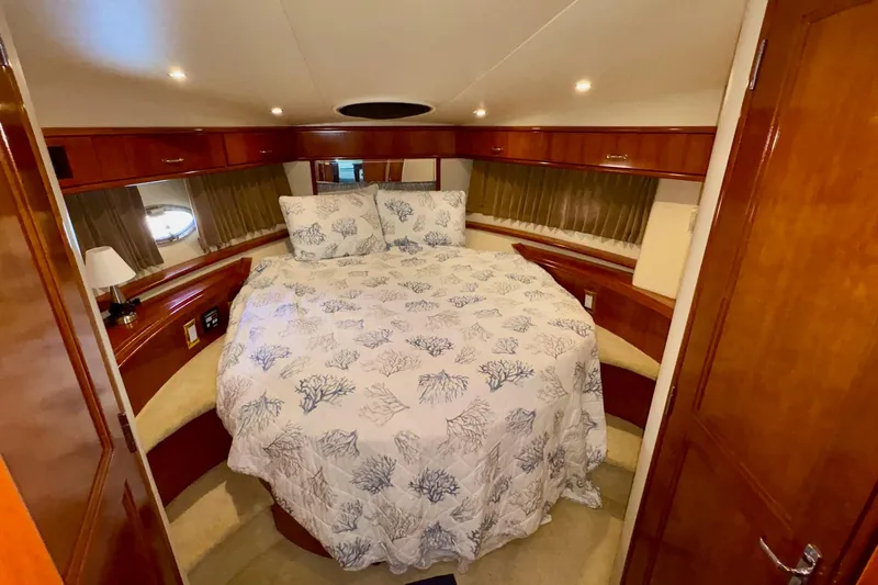  Yacht Photos Pics Luxurious bedroom interior of 2003 Carver 396 Motor Yacht with elegant wood finishes.