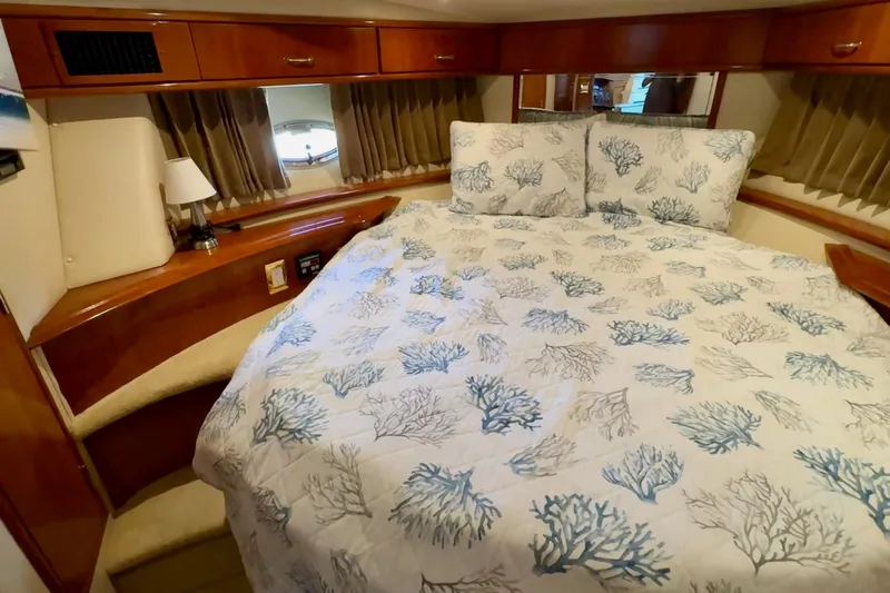  Yacht Photos Pics Luxurious bedroom in 2003 Carver 396 Motor Yacht with coral-patterned bedding.