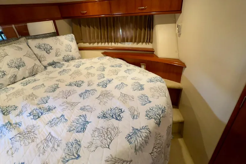 Yacht Photos Pics Cozy bedroom in 2003 Carver 396 Motor Yacht with coral-patterned bedding.