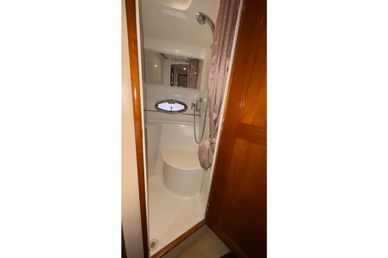  Yacht Photos Pics Bathroom interior of 2003 Carver 396 Motor Yacht with shower and porthole window.