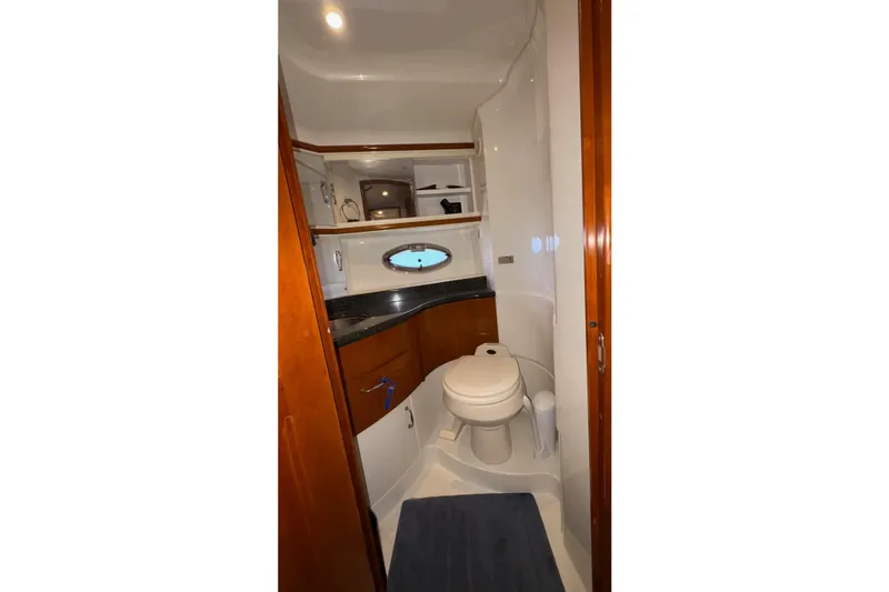  Yacht Photos Pics 2003 Carver 396 Motor Yacht bathroom with wood accents and porthole window.
