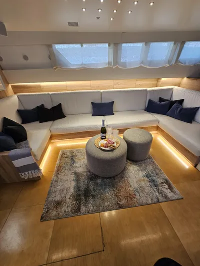  Yacht Photos Pics Luxurious interior of 1991 CIM Maxi 88 Cutter Sloop with cozy seating and elegant decor.