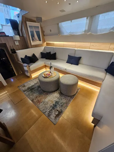  Yacht Photos Pics Luxurious interior of 1991 CIM Maxi 88 Cutter Sloop with elegant seating and ambient lighting.