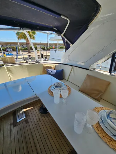  Yacht Photos Pics Luxurious 1991 CIM Maxi 88 Cutter Sloop yacht interior with elegant dining setup.