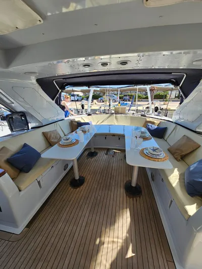  Yacht Photos Pics Luxurious interior of 1991 CIM Maxi 88 Cutter Sloop with elegant dining setup.