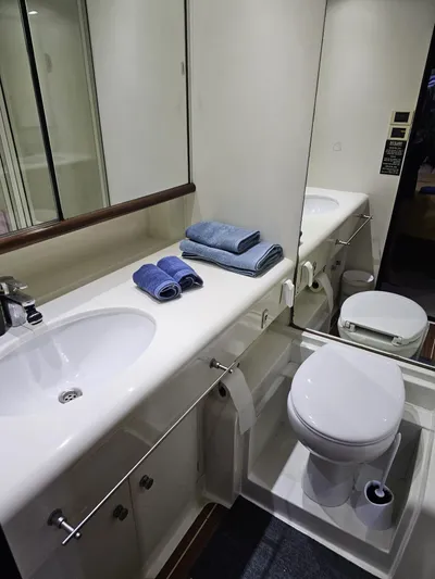  Yacht Photos Pics Luxurious bathroom in 1991 CIM Maxi 88 Cutter Sloop, featuring sink, toilet, and towels.