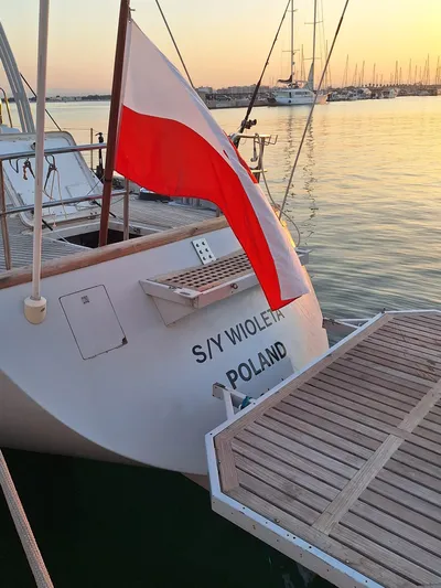  Yacht Photos Pics CIM Maxi 88 Cutter Sloop, 1991, docked with Polish flag at sunset.