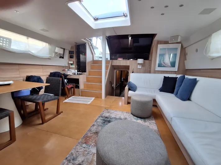  Yacht Photos Pics Spacious interior of 1991 CIM Maxi 88 Cutter Sloop with modern furnishings and skylight.