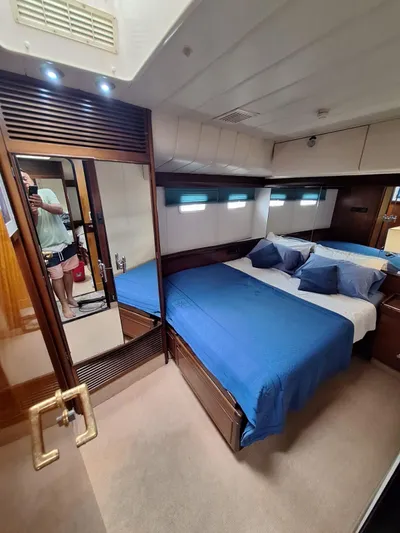  Yacht Photos Pics Luxurious bedroom interior of 1991 CIM Maxi 88 Cutter Sloop with blue bedding.