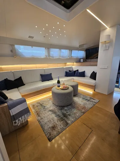  Yacht Photos Pics Luxurious interior of 1991 CIM Maxi 88 Cutter Sloop with elegant seating and ambient lighting.