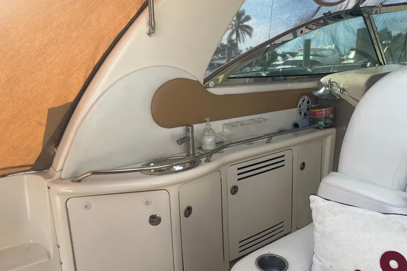  Yacht Photos Pics 2003 Sea Ray 410 Express Cruiser interior with seating, storage, and window view.