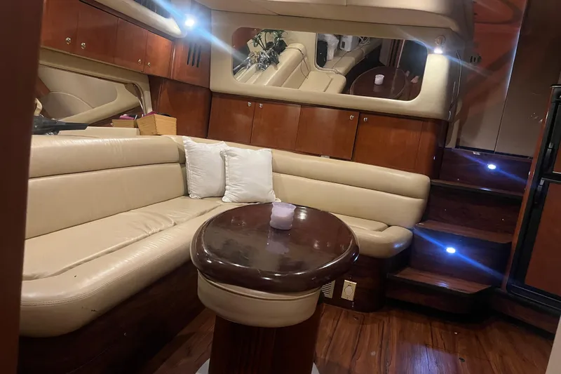  Yacht Photos Pics Luxurious interior of 2003 Sea Ray 410 Express Cruiser with leather seating and wooden accents.