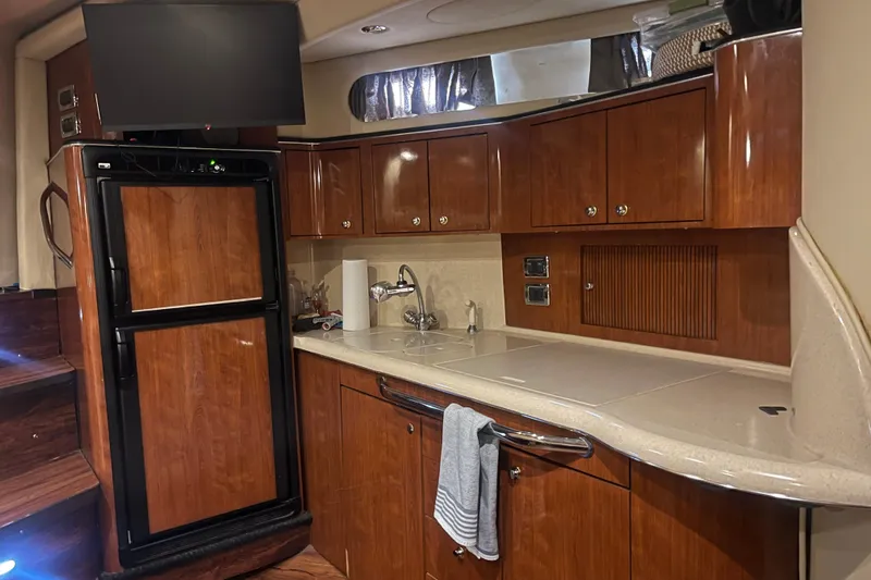  Yacht Photos Pics 2003 Sea Ray 410 Express Cruiser kitchen with wood cabinets and modern appliances.