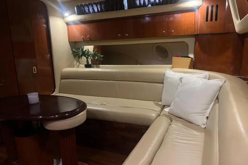 Yacht Photos Pics Luxurious interior of 2003 Sea Ray 410 Express Cruiser with leather seating and wooden accents.