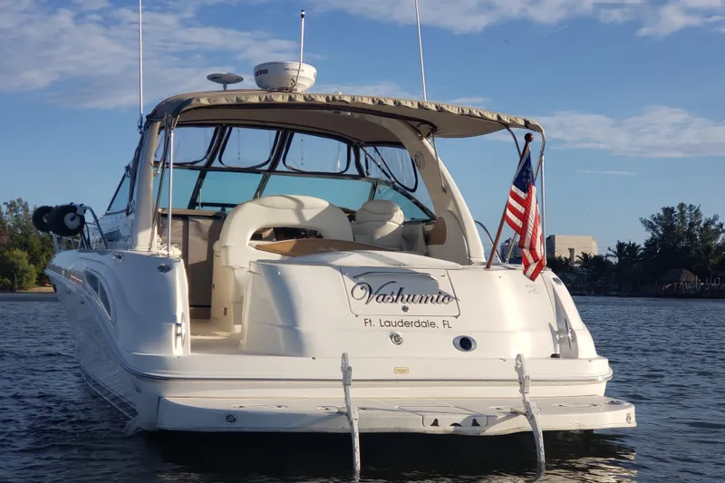  Yacht Photos Pics 2003 Sea Ray 410 Express Cruiser on water, American flag, Fort Lauderdale.