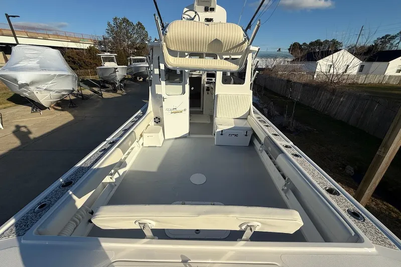 Daybreak Yacht Photos Pics 2023 Steiger Craft 31 Chesapeake boat with spacious deck and seating, docked outdoors.