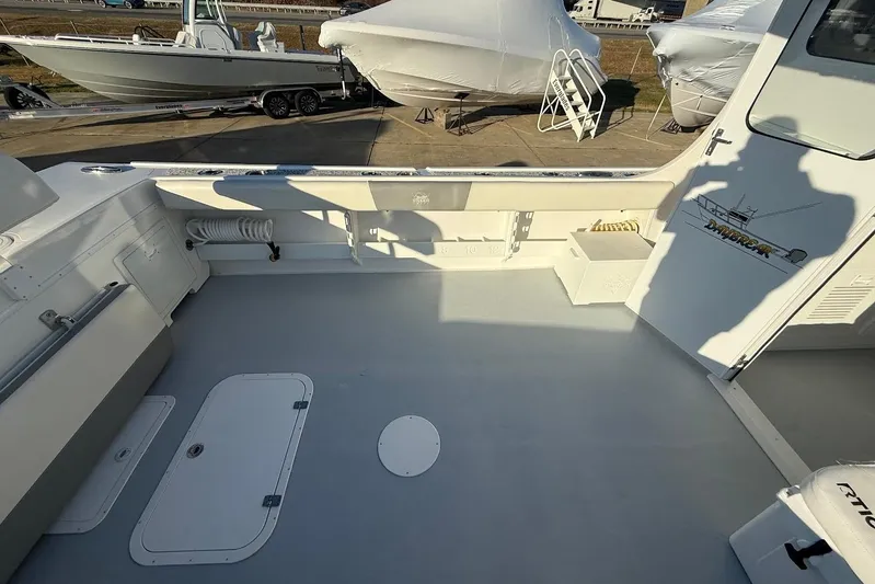 Daybreak Yacht Photos Pics 2023 Steiger Craft 31 Chesapeake boat deck with storage compartments and fishing gear.