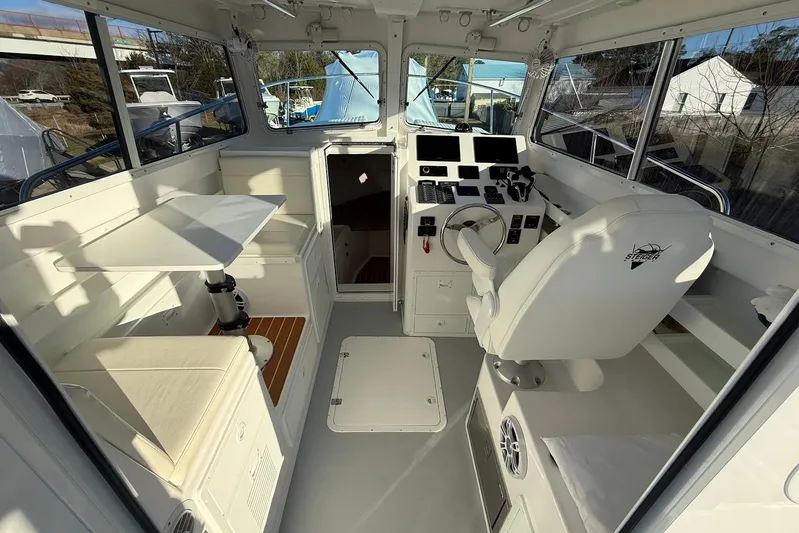 Daybreak Yacht Photos Pics Interior of 2023 Steiger Craft 31 Chesapeake boat, featuring helm and seating area.