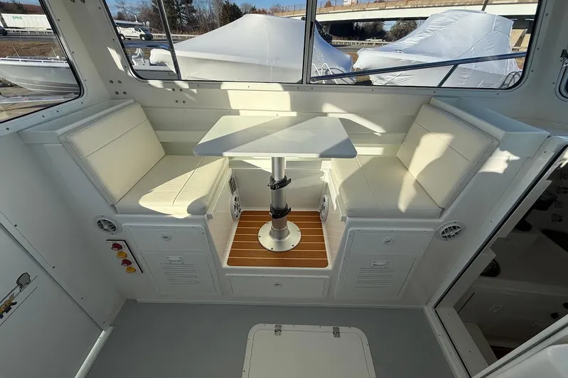 Daybreak Yacht Photos Pics Interior of 2023 Steiger Craft 31 Chesapeake boat with seating and table.