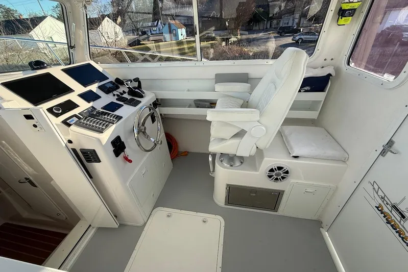 Daybreak Yacht Photos Pics Interior of 2023 Steiger Craft 31 Chesapeake boat with helm, controls, and seating.