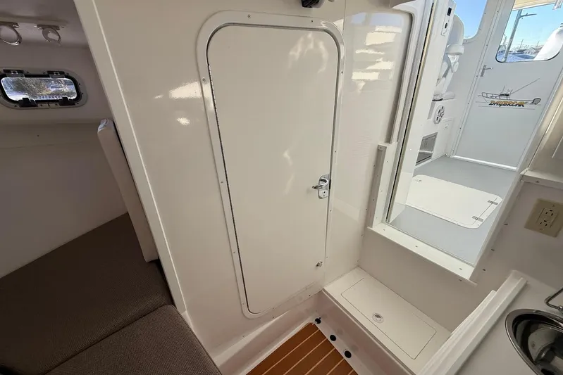 Daybreak Yacht Photos Pics Interior of 2023 Steiger Craft 31 Chesapeake boat, featuring cabin door and seating area.