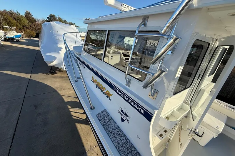 Daybreak Yacht Photos Pics 2023 Steiger Craft 31 Chesapeake boat docked, showcasing sleek design and modern features.