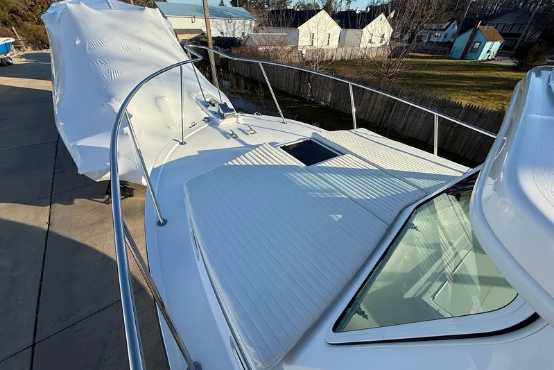 Daybreak Yacht Photos Pics 2023 Steiger Craft 31 Chesapeake boat deck with railing and hatch, docked outdoors.