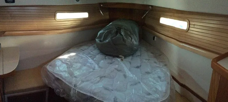 Catalina 425 In Stock Yacht Photos Pics 2024 Catalina 425 cabin interior with wooden paneling and a cozy bed.